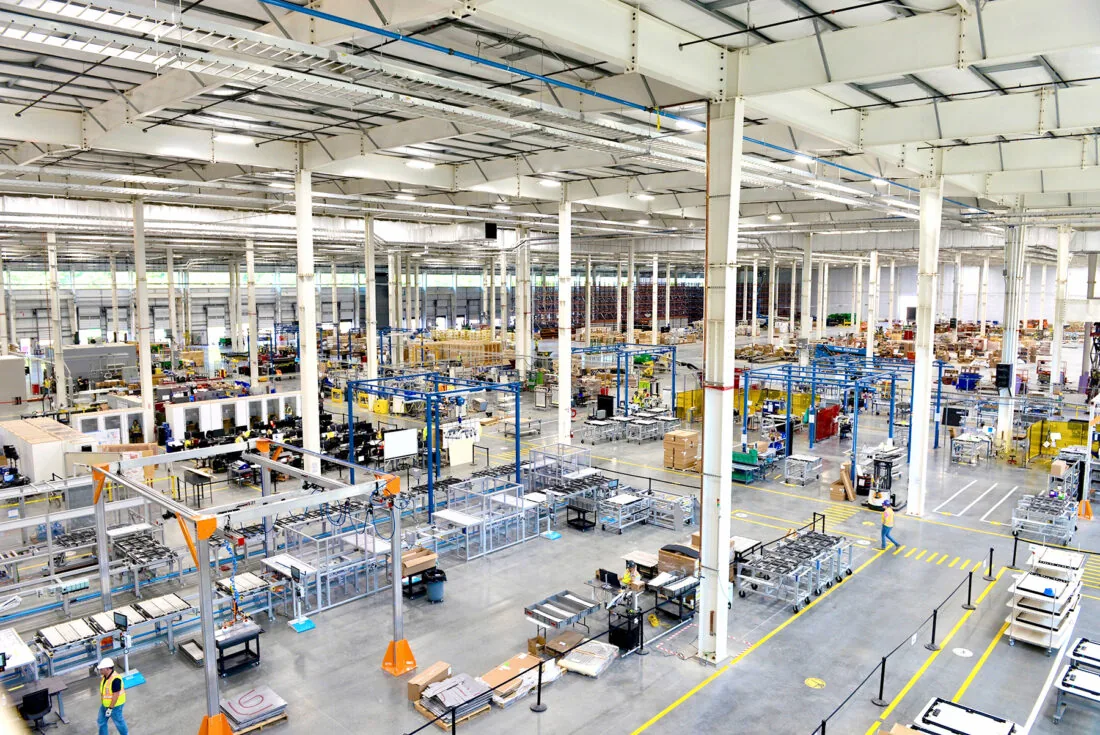 Manufacturing factory floor with workers and machinery